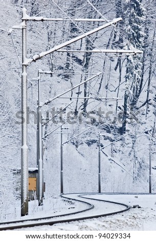 Vertical shot of frozen rail tracks and electric grid poles