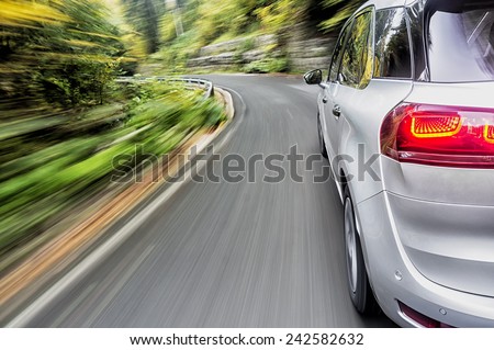 Generic car form the future driving fast on a mountain road