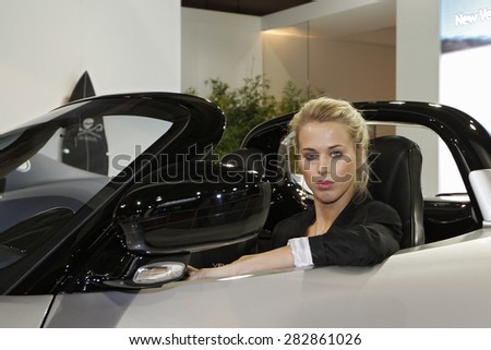 Paris, France - September 30: Beautiful hostess by the car on Paris Motor Show on September 30, 2010 in Paris.