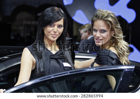 Paris, France - September 30: Beautiful hostesses by the car on Paris Motor Show on September 30, 2010 in Paris.