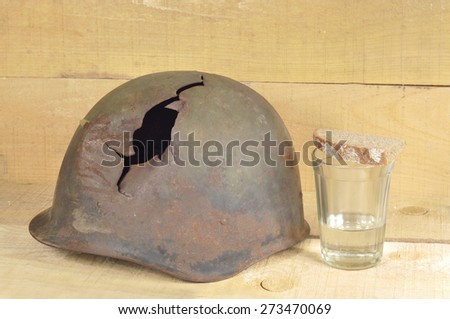old helmet Soviet World War II soldiers and glass vodka