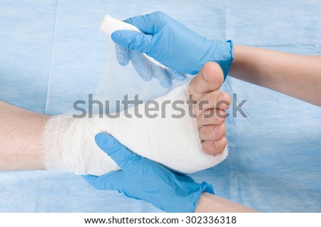 doctor bandages leg