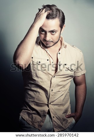 Portrait of a handsome stylish man with a cool hairstyle. Studio shoot.