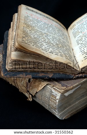 old open religious books on black