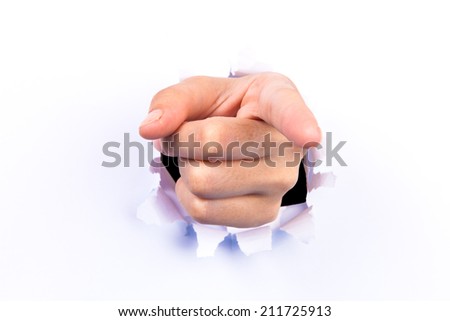 Hand pointing with finger out of torn hole in white wall. All on white background.