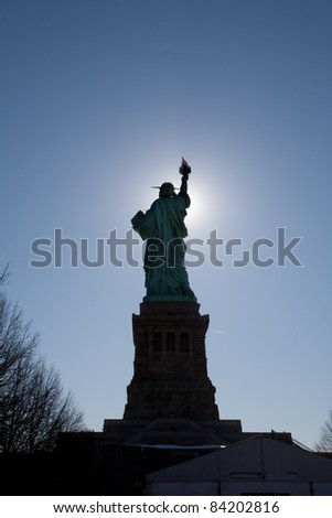 Statue of Liberty in New York.  The silhouette emphasizes the form of the statue.