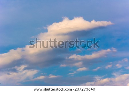 Beautiful blue sky with a cloud of unusual interesting shape, beautiful background for your design.