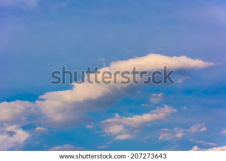 Beautiful blue sky with a cloud of unusual interesting shape, beautiful background for your design.
