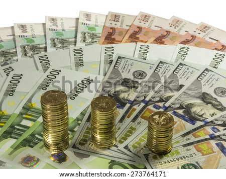 Stacks of coins 10 ruble banknote on the background of 1000, 5000 rubles, 100 euros and 100 dollars. Isolated image.