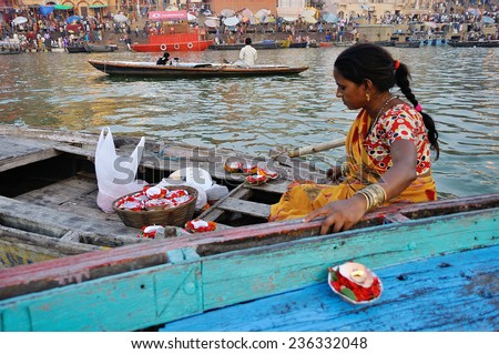 VARANASI, INDIA - OCTOBER 23: Unidentified woman sells the ritual candle on Diwali festival on October 23, 2014 in Varanasi, Uttar Pradesh, India.