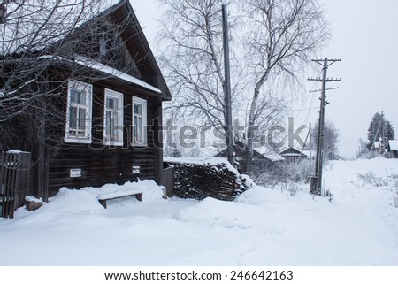 traditional russian house in village covered with snow in winter