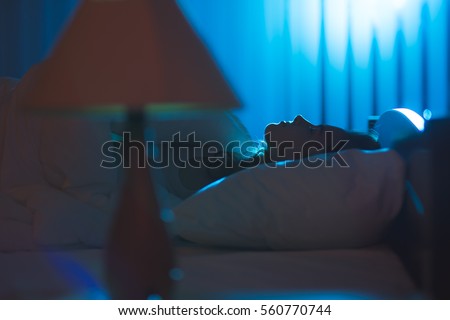 The cute woman sleeping on the bed. Evening night time