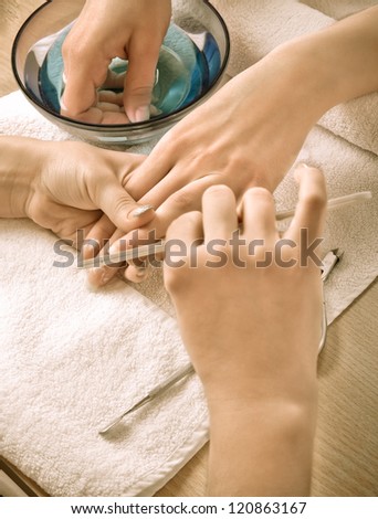 Woman\'s hands with nail file (retro styled)
