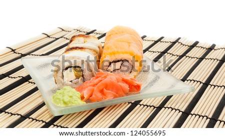 Maki sushi with wasabi on bamboo sushi mat isolated