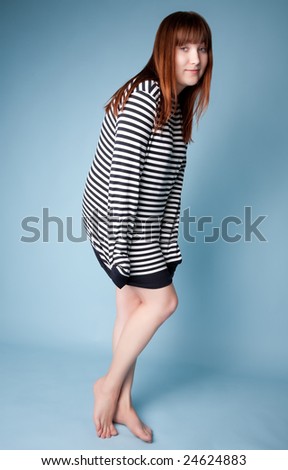 Shy red haired girl in striped shirt