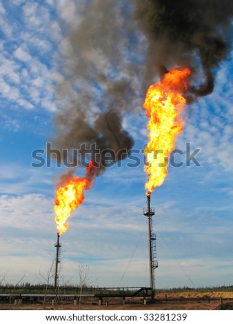 Two gas flares burning and smoking