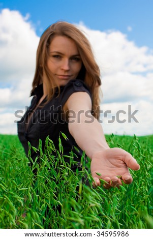 Young woman giving hand on field