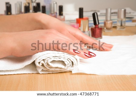 Woman\'s hands with manicure on the white towel