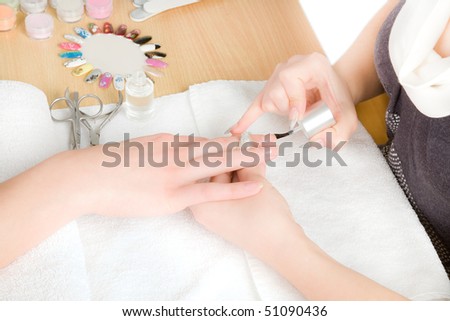 Woman\'s hands nail brush drawing on nails