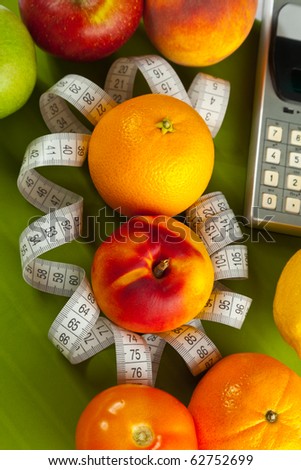 Concept of healthy food (orange, peach and tape measure)