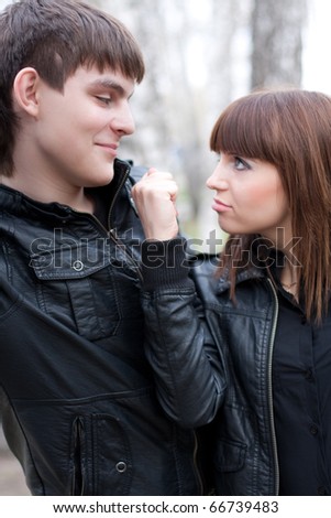 Woman shaking fist at her boyfriend outdoors