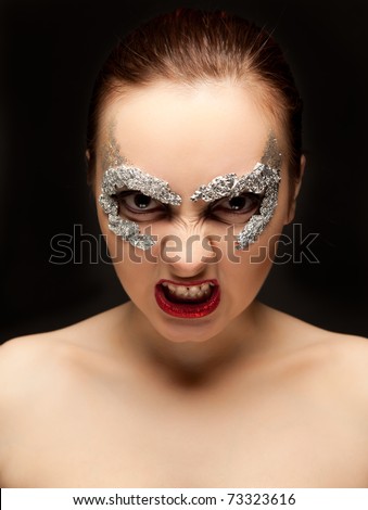 Portrait of fury woman in foil mask looking to the camera