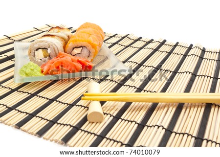 Maki sushi with wasabi on bamboo sushi mat