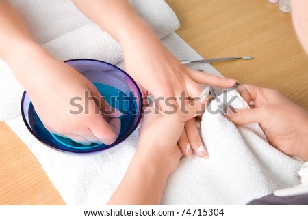 Woman\'s hands with nail towel