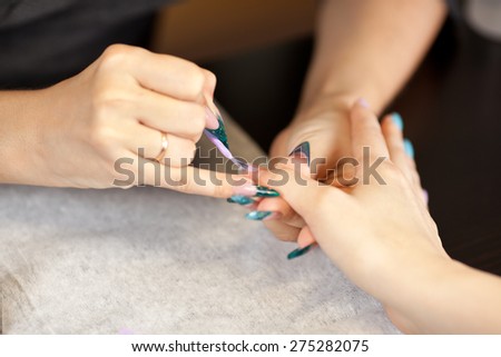 Picture of woman at manicure procedure at nail studio