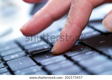 Typing on a laptop