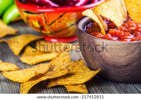 Salsa with tortilla chips and chilli peppers.Concept