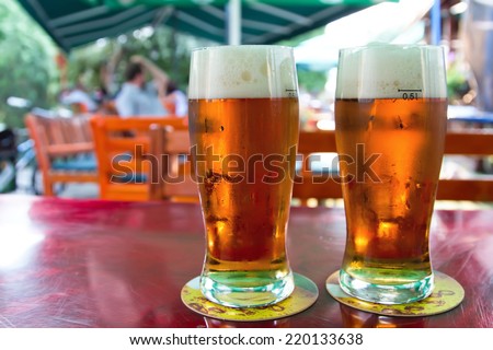 Two beers on table in the garden pub.