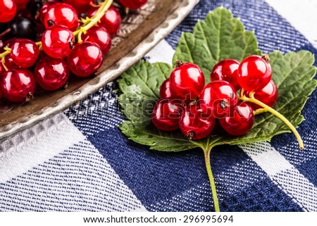 Red currant sponge cake. Plate with Assorted summer berries, raspberries, strawberries, cherries, currants, gooseberries. Fresh summer garden fruit