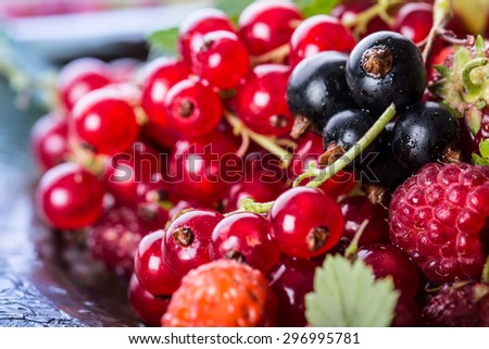 Red currant sponge cake. Plate with Assorted summer berries, raspberries, strawberries, cherries, currants, gooseberries. Fresh summer garden fruit