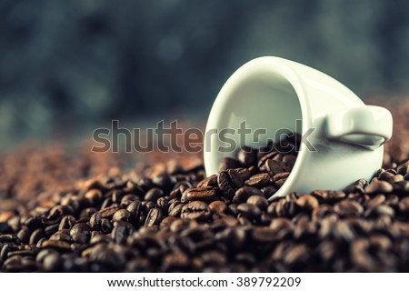 Coffee. Coffee beans. Coffee cup full of coffee beans. Toned image.