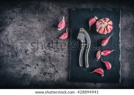 Garlic. Fresh garlic. Red garlic. Garlic press. Violet garlic.Garlic background. garlic bulbs. Slate board. Wooden board.