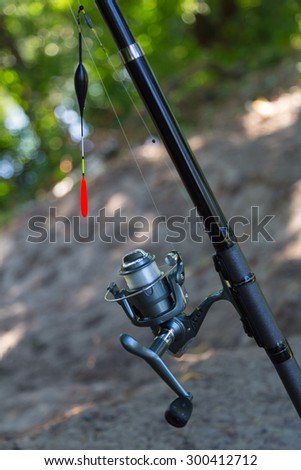 Fishing rod with inertialess reel and  float close-up