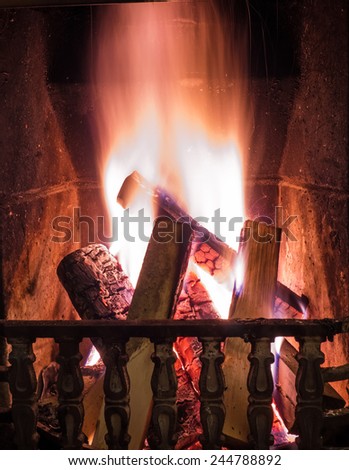 Burning fire in the fireplace. Cosy place