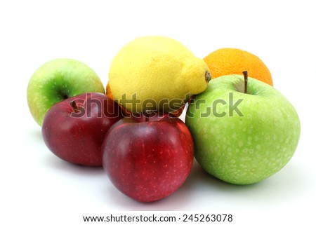 Four apples, lemons and oranges on a white background