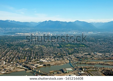 Aerial view of Vancouver downtown city in British Columbia with beautiful mountains in background