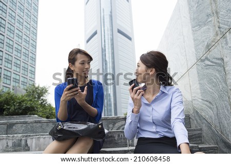 Business woman to talk happily sitting on the stairs