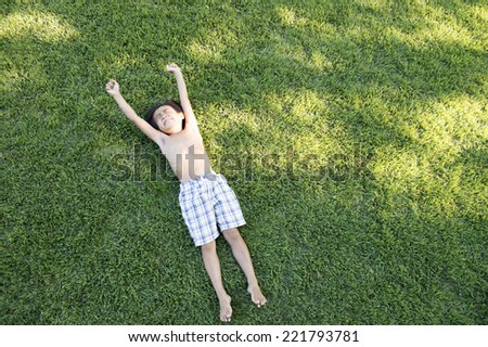 Boy to lie down on the lawn