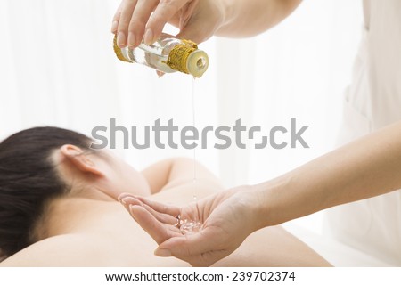 The woman is putting aroma oil on a hand