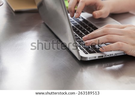Busy woman inputting data to the office computer