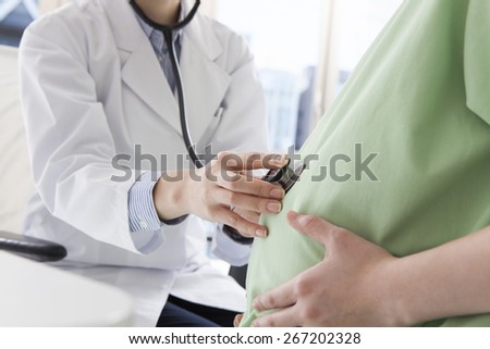 Pregnant woman with doctor . Isolated.