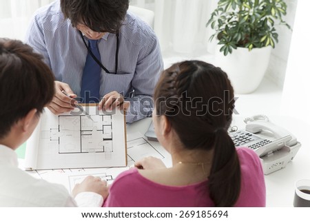 Couple talking to financial planner at home