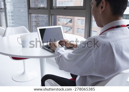 Close-up Of man Using Laptop On desk
