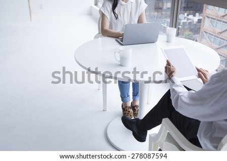 Business people working at office with paperwork using tablet and laptop