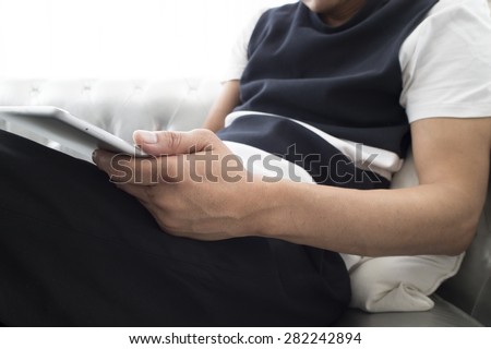 Happy man relaxing on sofa with smart phone