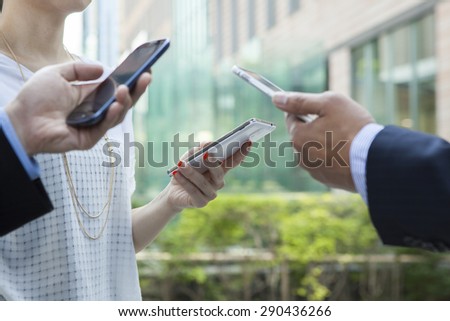 A group of friends chatting with their smartphones